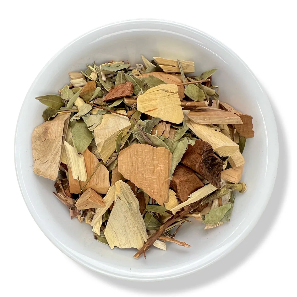 White bowl filled with dried herbs and spices on a white background